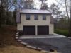 garage-door-view-of-custom-two-story-garage-retaining-wall-site-preparation