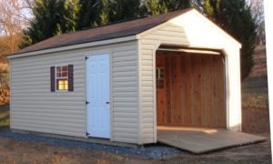 12x24 Vinyl Standard Portable Garage delivered to Maryland, Virginia, West Virginia. Gravel site preparation is complete under the portable garage as well as a wood ramp attached to the wood garage.