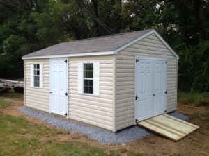 10x20 vinyl peak roof storage shed with gravel site preparation and wooden ramp in stalled by 4-outdoor inc.