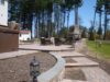 custom-patio-design-with-steps-retaining-wall-outdoor-fireplace