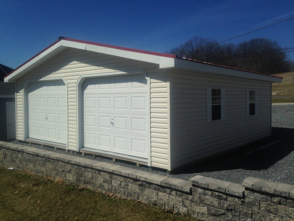 two car modular garage built at the shop and delivered in two halves prefabricated in maryland. delivery on truck and trailer into yard prefab garage, then assembled onsite. choose colors and placement. concrete pad can be completed by 4-outdoor.